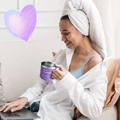 Relaxing mom with mug in hand at laptop