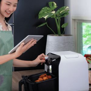 Woman reading directions for her Air Fryer