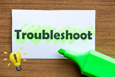 Sign with "Troubleshoot" and idea lightbulb