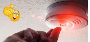Smoke alarm on ceiling being tested