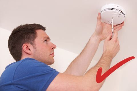 Man installing a smoke detector
