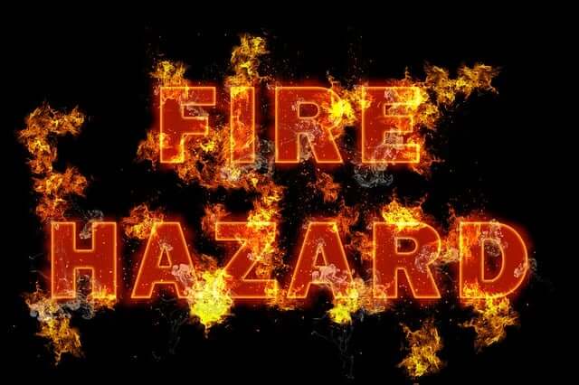 Image on black background with Fire Hazard in red with fire erupting from letters.