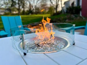 Gel-fueled fire pit on blue table