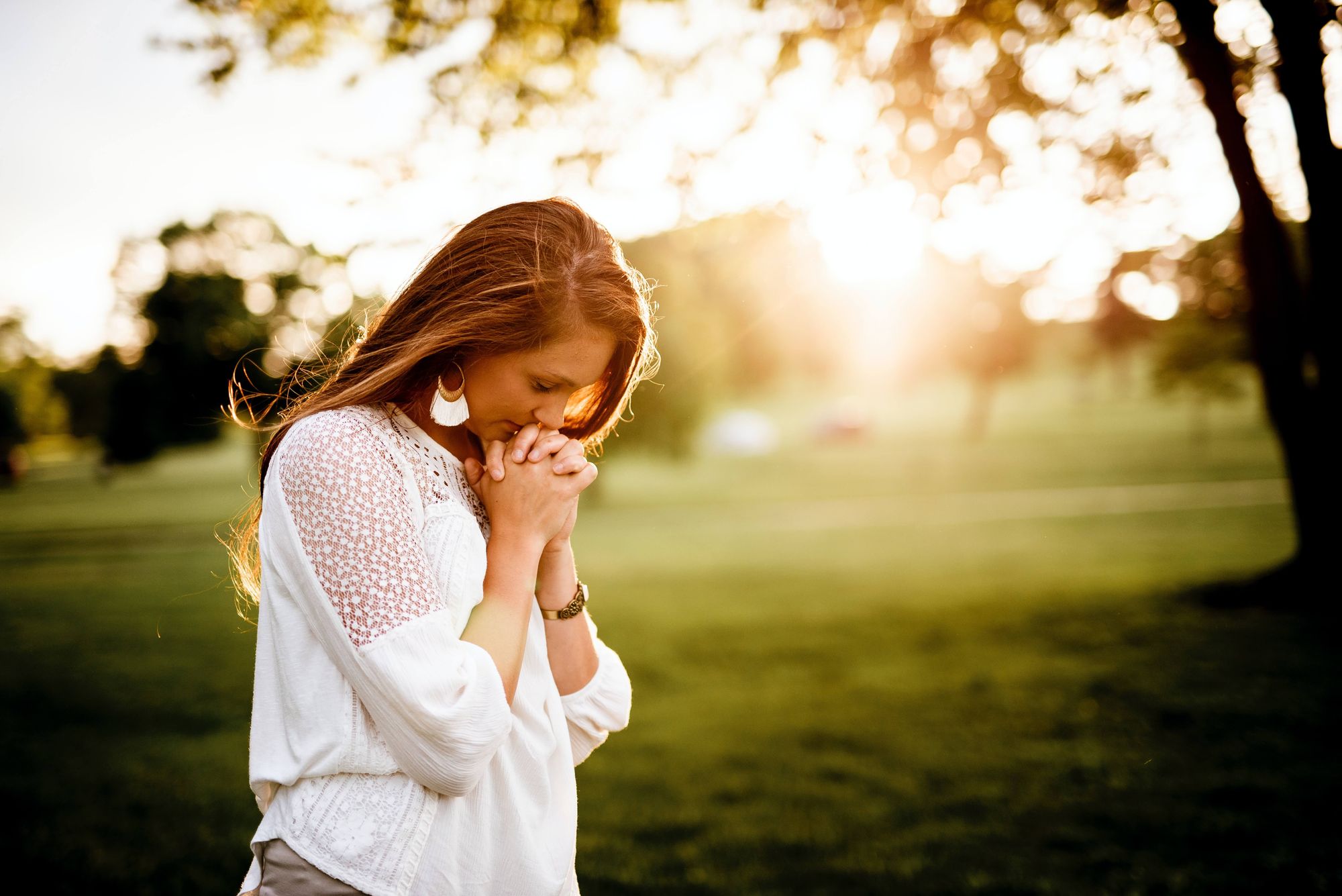 Woman praying in an outdoor setting