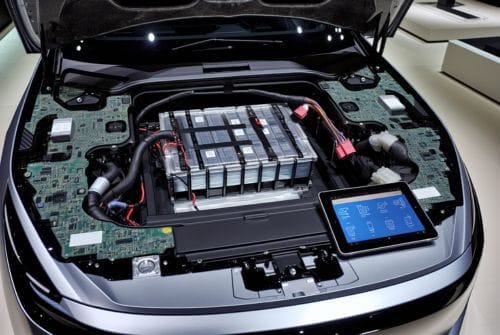 Battery shown in EV car with hood lifted up