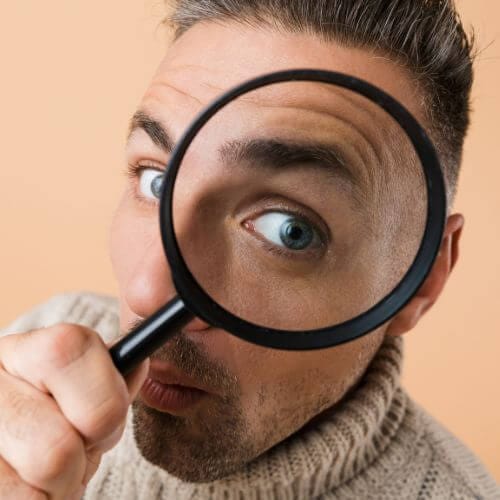 Taking a closer look - man with magnifying glass