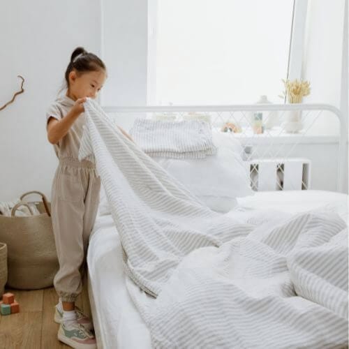 child making up bed